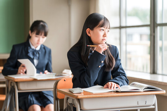 Female elementary, middle, and high school students who look unmotivated and still gaze outside during class (apathetic, rebellious, grumpy)