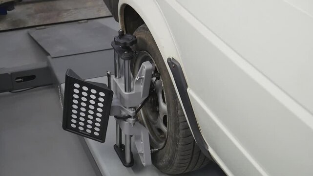 Adjusting the camber-toe of car wheels on a modern stand in a car service, close-up of the equipment.