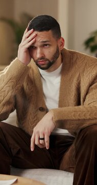 Mental health, overthinking or man on sofa with regret, anxiety trigger or memory of past trauma. Reflection, overwhelmed or person in house with stress, frustration or guilt with emotional thoughts.