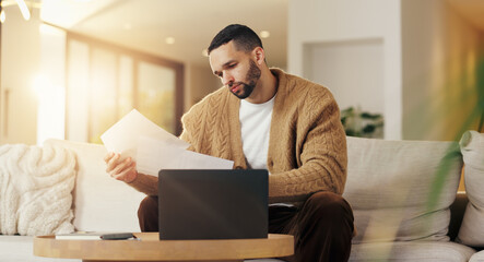 Reading, paperwork and man with laptop in lounge, financial planning and checking home loan...