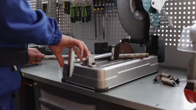 Students work with a cutting machine in a modern training workshop during a metalworking practice.