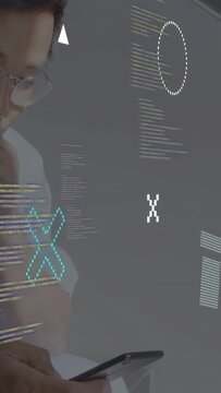 Vertical video: Tech dev raising phone tapping as holo code and icons shifting with taps reviewing