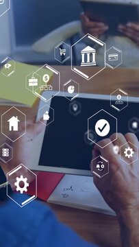 Vertical video: Man tapping tablet at meeting, launching finance UI with bank, chart icons for demo