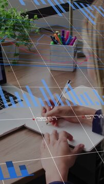 Vertical video: Woman placing pen to notebook, writing, bringing grids, bar or pie charts for busine