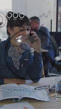 Vertical video: Woman taking call, speaking while checking figures HUD globe showing business data