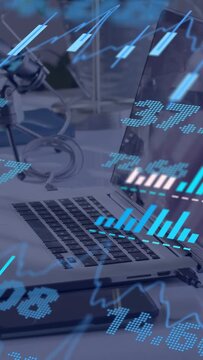 Vertical video: Data feed driving overlay, laptop centered while charts pulsing for market updates