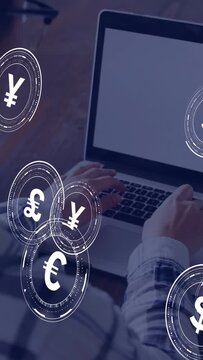 Vertical video: Woman typing at laptop, currency icons swirling over keyboard, showing finance flow