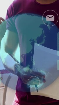 Vertical video: Man holding paper pointing with woman as AR globe and icons animating for IT review