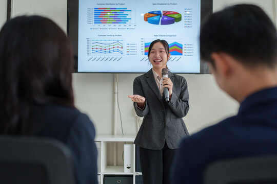 Businesswoman presenting data insights during corporate meeting