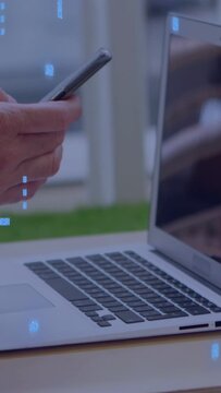 Vertical video: Man tapping and swiping phone for business at laptop, blue overlay crossing hands