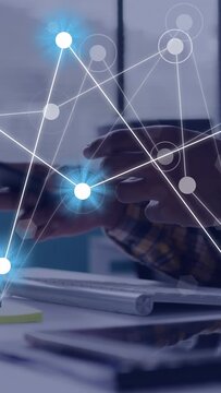 Vertical video: Man tapping phone, sparking network mesh across hands, typing on keys for data sync