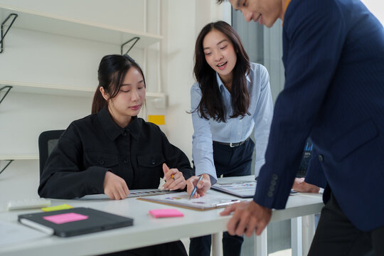 Business team collaborating on project in modern office
