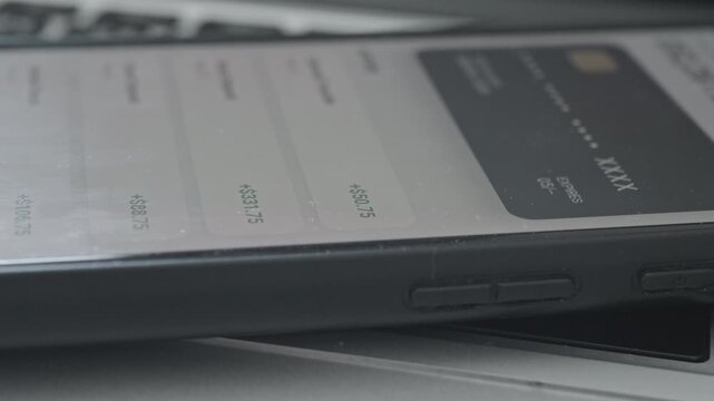 Concept of passive income and wealth growth with banking app displaying frequent deposits
