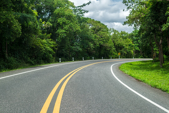 Beautiful curved road in the forest. Road background.