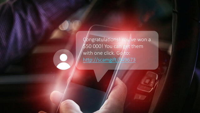 Scam message claiming someone has won money sent to a mobile device while driving a car