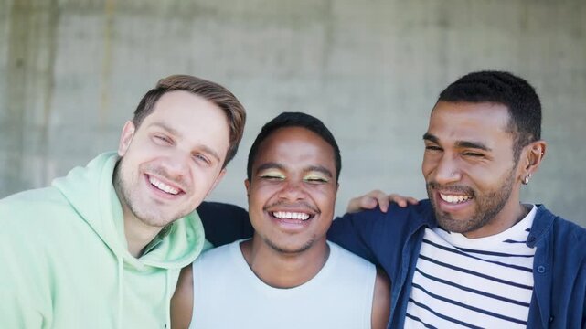 Happy diverse male friends having fun outdoors - Lgbt community and pride month event concept