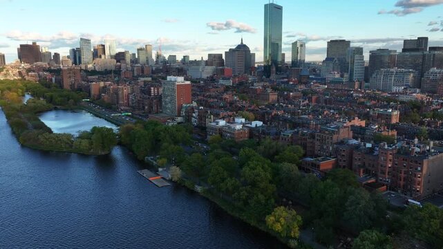 Drone shot toward Boston's historic brownstone houses and the city skyline, eve