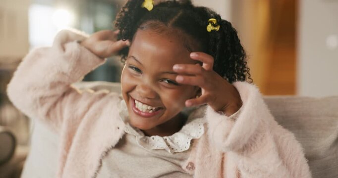 Cute, face and silly of black girl on sofa in home living room for child development or growth. Adorable, goofy and tongue out with happy kid on couch in apartment for humor, relax or weekend chill