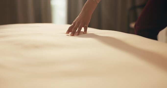 Woman, hand and touch sheets on bed for material quality, fabric texture and interior design in home. Person, duvet inspection and check comfort of mattress with soft linen, cotton or review in house