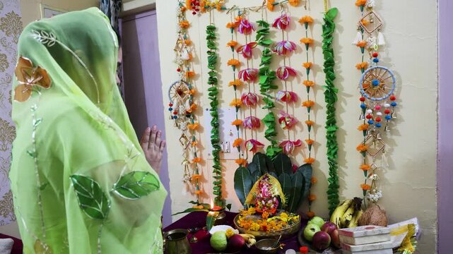 devotee with folded hands offering prayer to lord ganpati bappa on ganesh chaturthi celebration