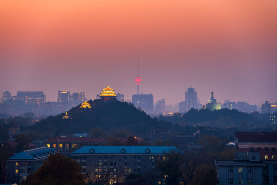 Sunset views along Beijing's central axis, including Wanchun Pavilion in Jingshan Park, the Central Radio and Television Tower, and the White Pagoda in Beihai Park.