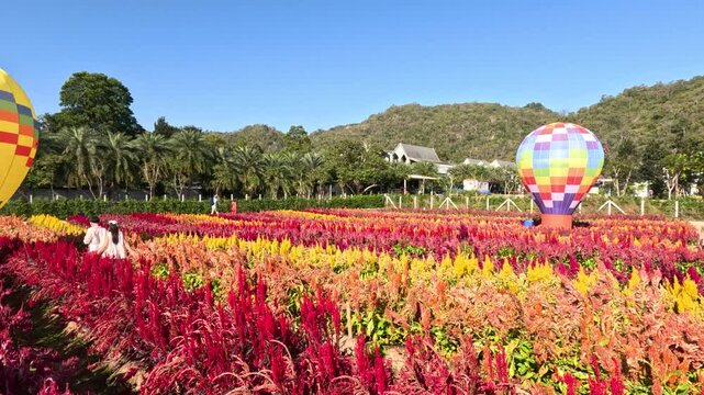 Children Walking Through Colorful Flower Field With Hot Air Balloon