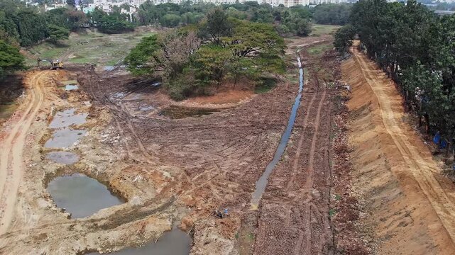 Drone view shows Drainage Channel Traversing Muddy Area for Effective Water Flow Control