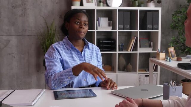 Human resources manager shaking hands with job applicant