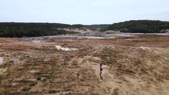 Woman photographer captures kaolin quarry in Ukraine from an aerial view with an open pit and porcelain clay production