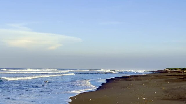 Quiet sandy coastline with blue ocean waves