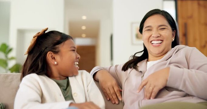 Laughing, mother and child with kiss on sofa for bonding together, funny weekend and connection. Forehead, happy mom and daughter with affection in home for healthy relationship, security and joke