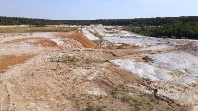 Woman photographer captures kaolin quarry in Ukraine from an aerial view with an open pit and porcelain clay production