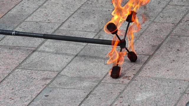 A circus performer performs a fire dance. Fire show.
