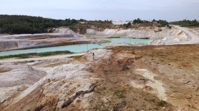 Woman photographer captures kaolin quarry in Ukraine from an aerial view with an open pit and porcelain clay production