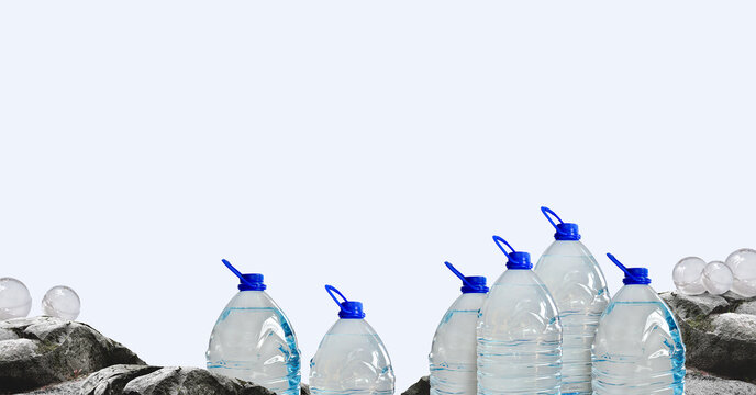 Spring water in a bottles. Rocky landscape, plastic 5 liter bottles, ice balls, wide view. Water beverage distribution, liquid containers, industry, water supplies