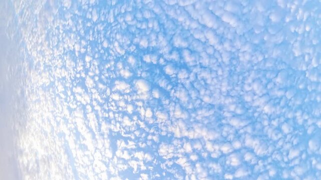 Rotating 360 camera view of clouds in blue sky, abstract atmospheric background with soft white cloud pattern 