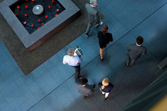 Top view of businesspeople walking through lobby
