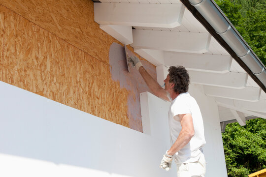 Europe, Germany, Rhineland Palatinate, Man insulating polystyrene