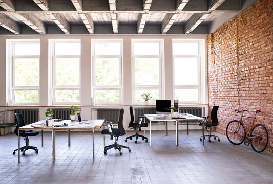 Coworking space and bicycle at brick wall in office