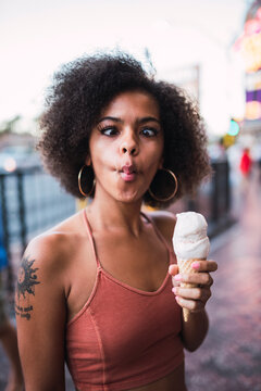 USA, Nevada, Las Vegas, portrait of young woman holding ice cream cone grimacing
