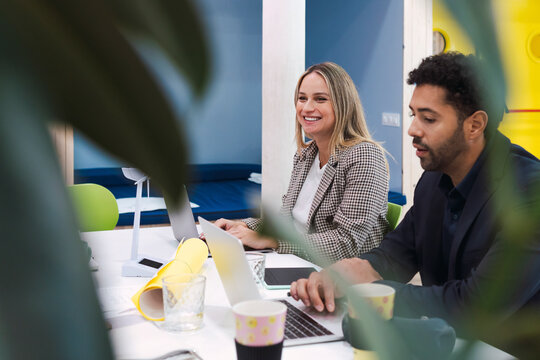 Business colleagues having a meeting with wind turbine model on table