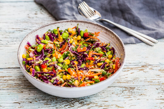 Quinoa salad with edamame, corn, carott, tomato, paprika, onions in a bowl