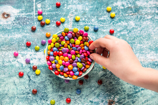 Girl's hand taking chocolate button