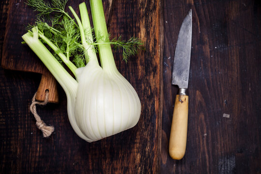 Fennel corm on chopping board, kitchen knife