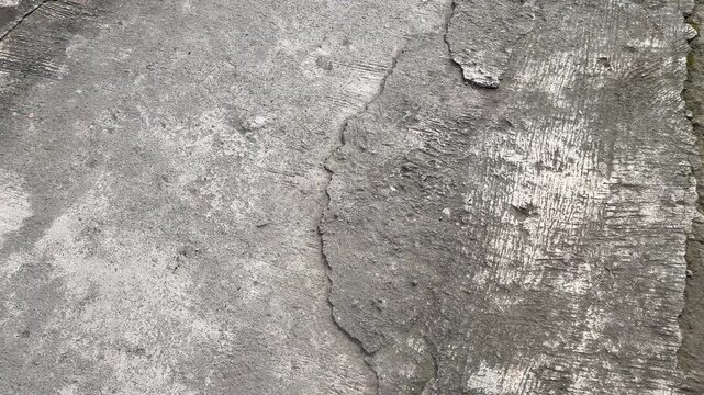Damaged concrete road surface with deep cracks