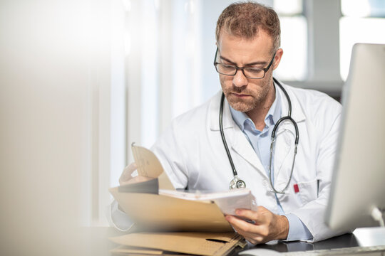 Doctor working at desk in medical practice