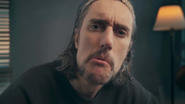 Comic guy surprised, approving nod, admires &ndash; close-up of a man indoors with warm cozy lighting showing puzzled, thoughtful, then gentle smiling relaxed expressions