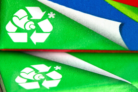 Close-up of a recycling symbol printed on toothpaste packaging.