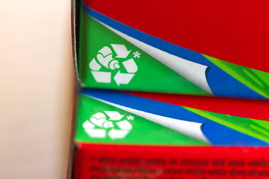 Close-up of a recycling symbol printed on toothpaste packaging.