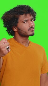 Greedy avaricious Indian man showing fig negative gesture, you dont get it anyway. Rapacious, avaricious, acquisitive. Body language. Refusal fig sign. Hindu boy isolated on chroma key background